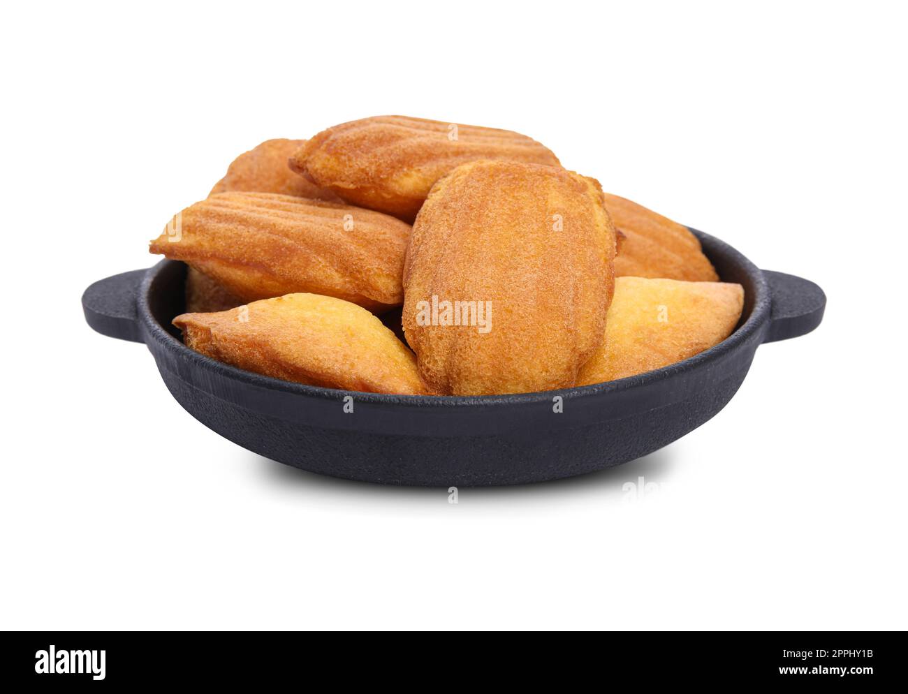 Frying pan with delicious madeleine cakes on white background Stock