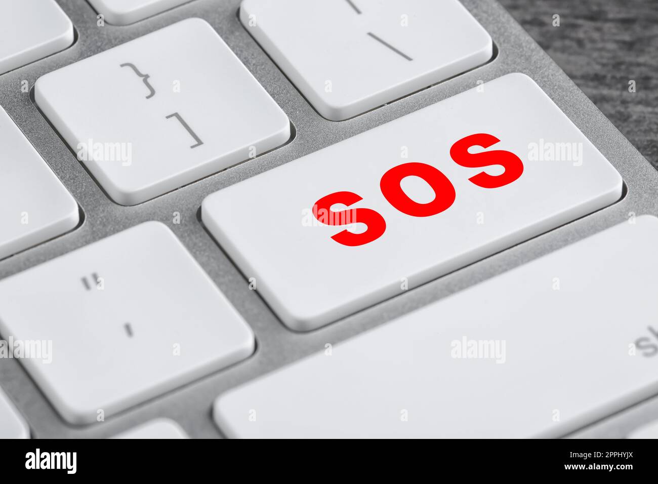 Button with word SOS on computer keyboard, closeup. Rescue concept Stock Photo