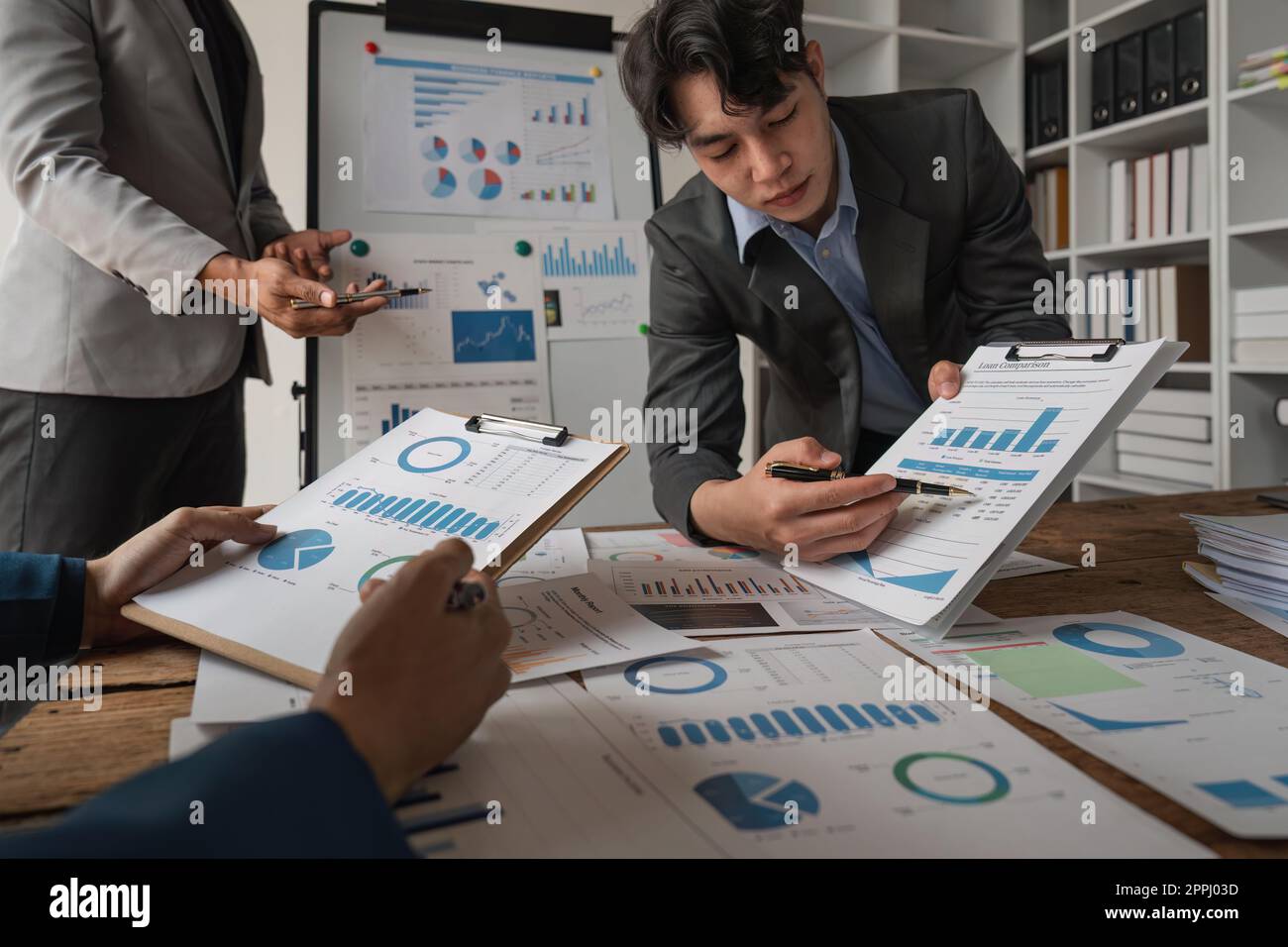 Business team analyzing income charts and graphs with laptop computer ...