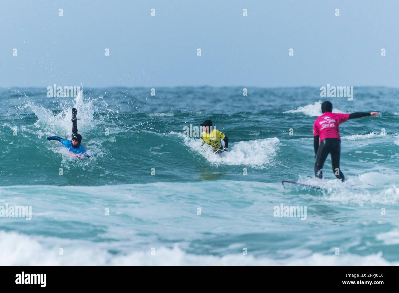 Competitors in the Rip Curl Grom Search surfing competition at Fistral in Newquay in Cornwall in the UK. Stock Photo