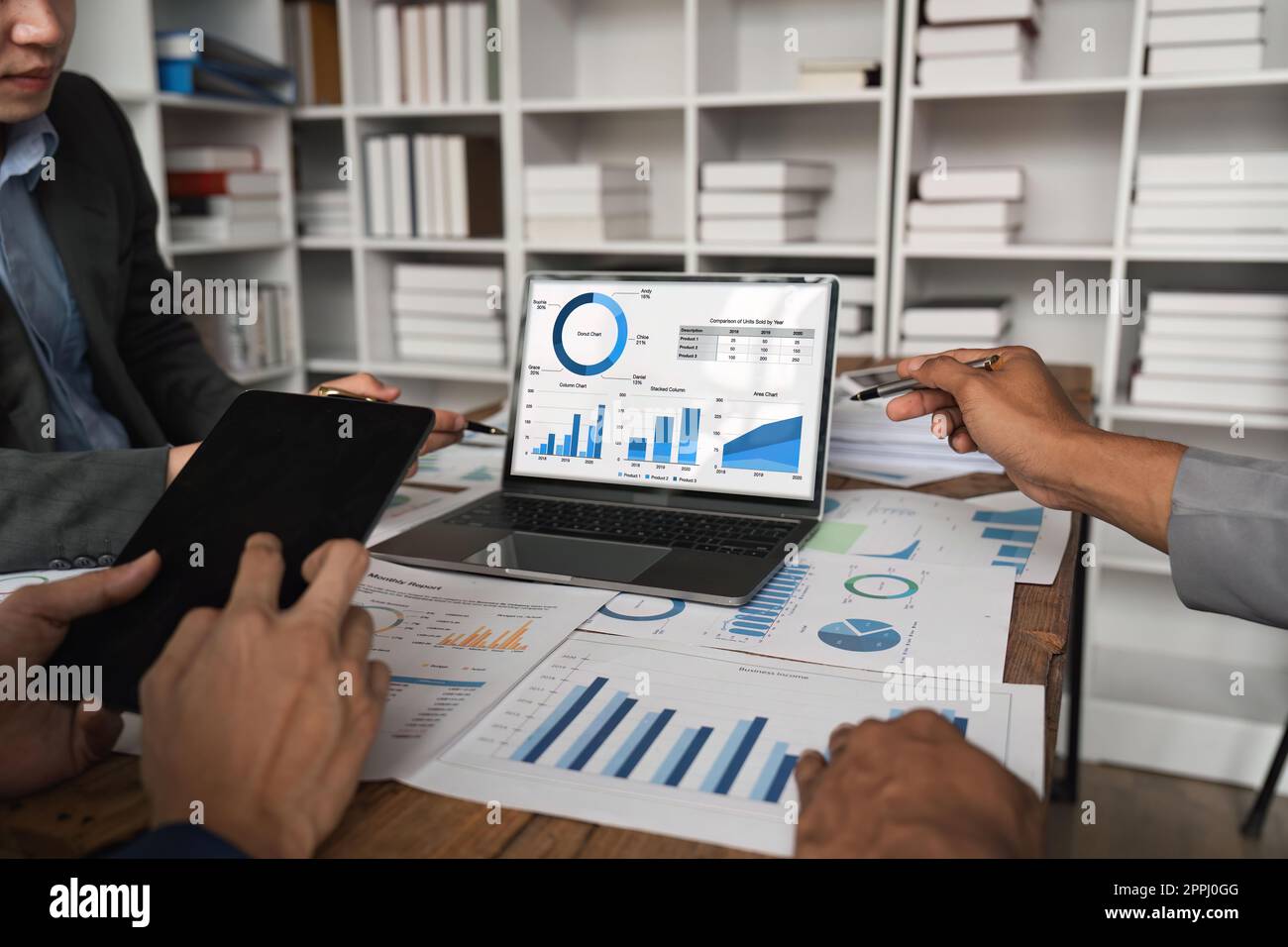 Business team analyzing income charts and graphs with laptop computer ...