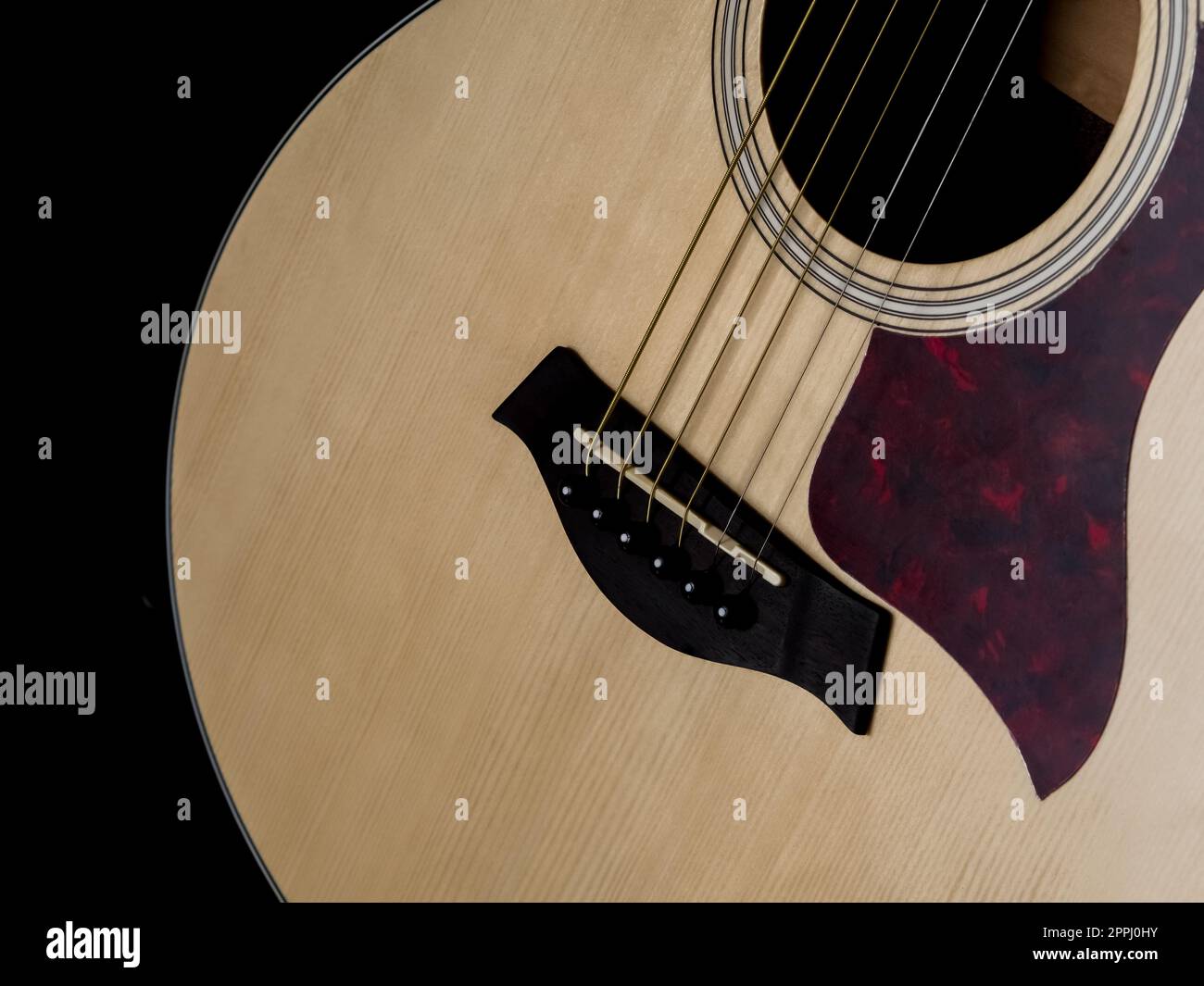 Close up shot of acoustic guitar. Strings, sound hole , bridge, pickguard Stock Photo