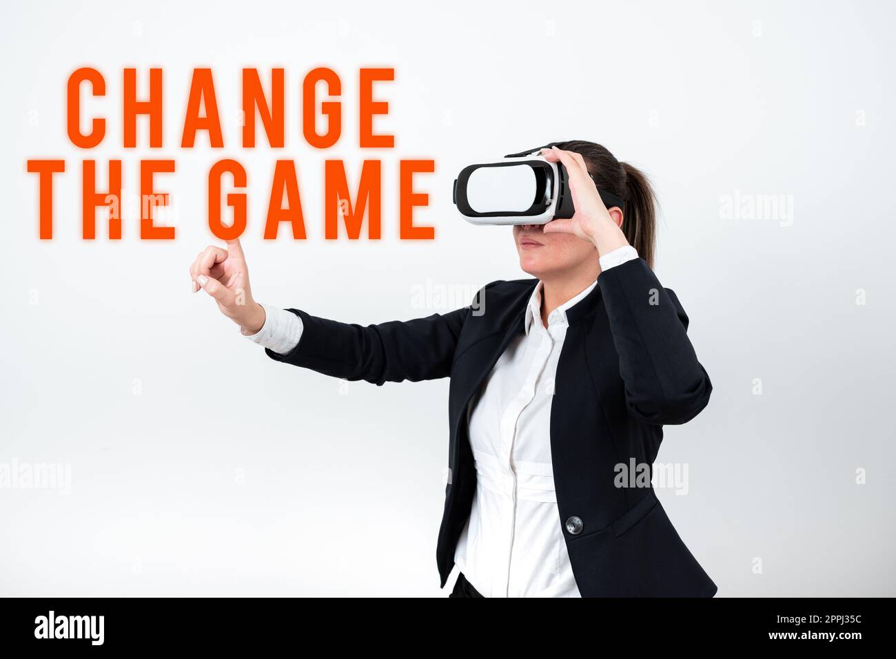 Conceptual display Change The Game. Concept meaning Market study seeking specific potential clients Marketing Woman Wearing Vr Glasses And Pointing On Important Message With One Finger. Stock Photo