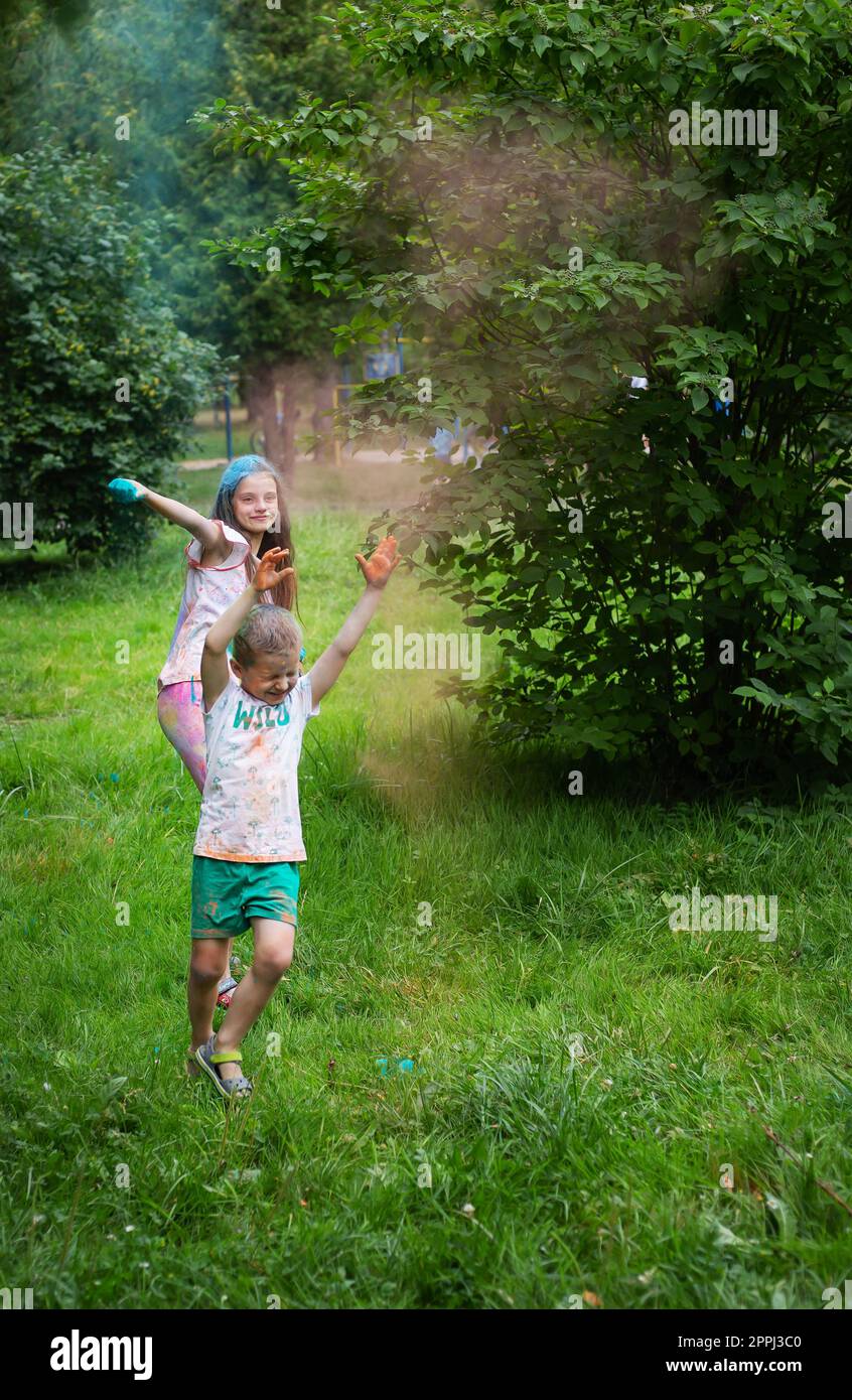 Lviv, Ukraine - July 18, 2021: Color Holi Festival, boy and girl throw colored paint. The holiday comes from India. Stock Photo