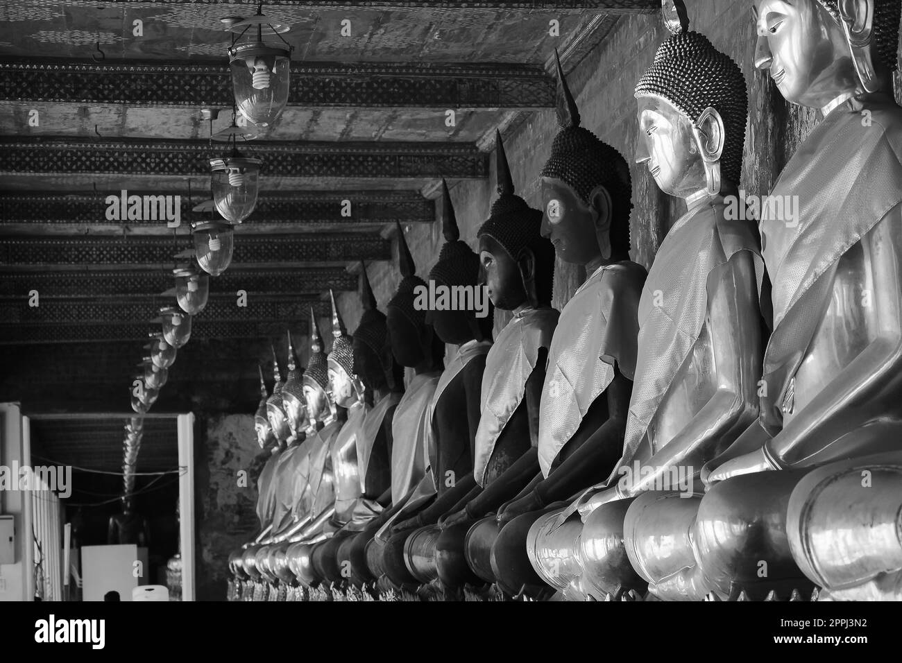 Golden Buddha beside old walls in Thai temples Stock Photo