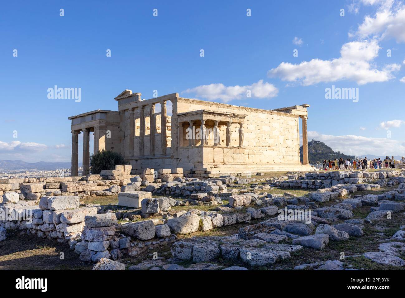 Group of tourists in front of  Erechtheion, Temple of Athena Polias on Acropolis of Athens, Greece Stock Photo