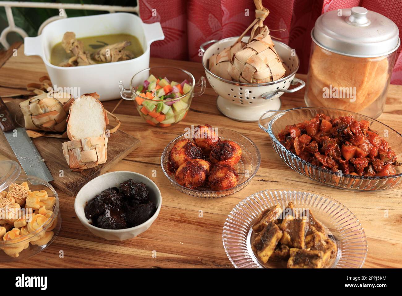 Hidangan Lebaran Menu Set with Ketupat, Rendang, Semur Tahu, Opor Ayam Chicken Curry, Shrimp Crackers, and Sambal Goreng Ati Kentang. Ied Al Fitr Fest Stock Photo