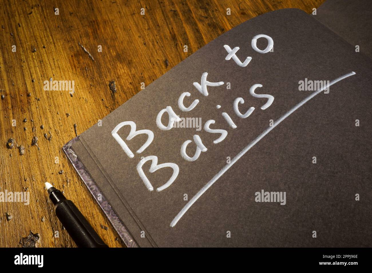 Notebook with handwritten inscription back to basics. Stock Photo