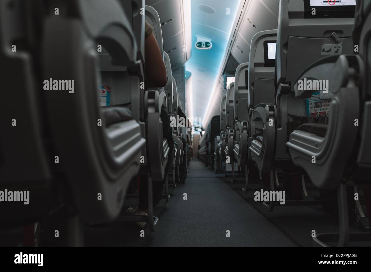 Aircraft interior with aisle and airplane seats Stock Photo