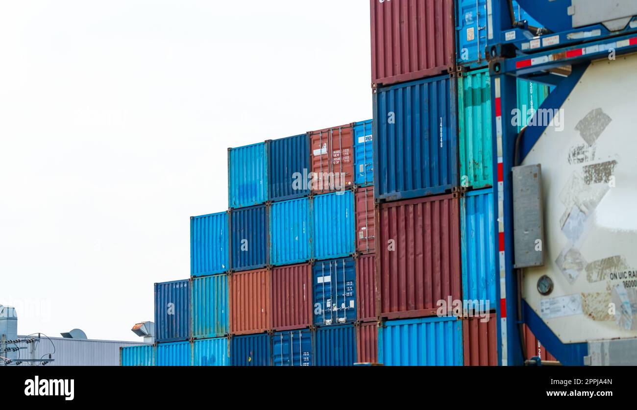 Container logistic. Cargo and shipping business. Container ship for import and export logistic. Container freight station. Logistic industry from port to port. Container at harbor for truck transport. Stock Photo