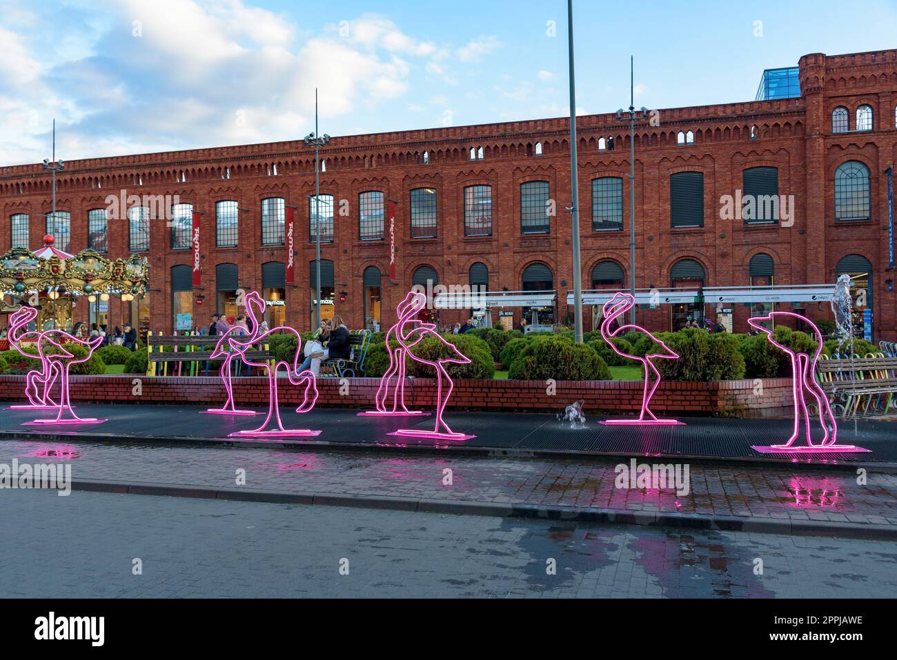 Lodz, Poland - 29 September, 2022: Pink flamingo neons in the fountain