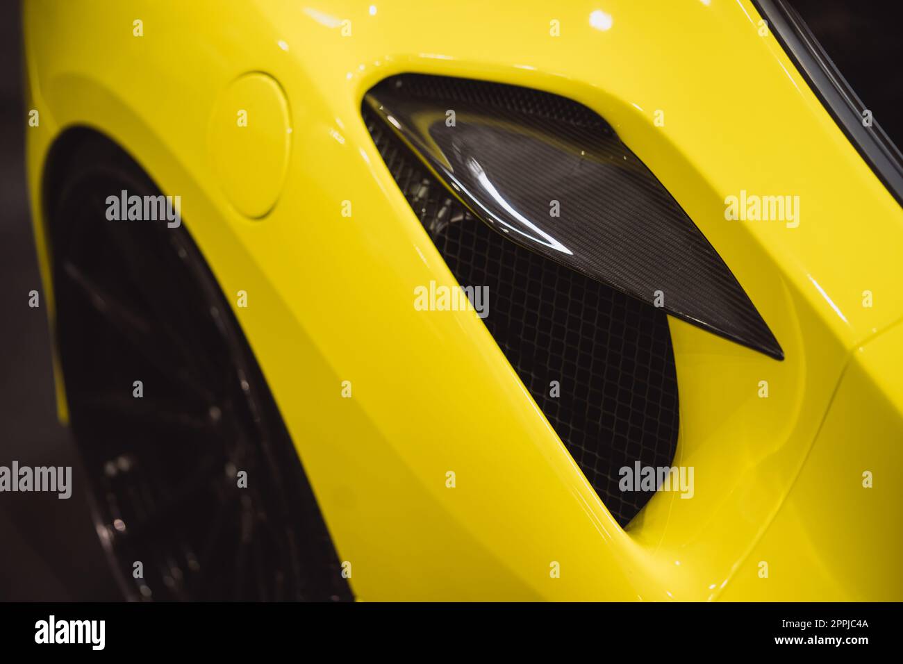 Aerodynamic yellow exotic supercar carbon part Stock Photo