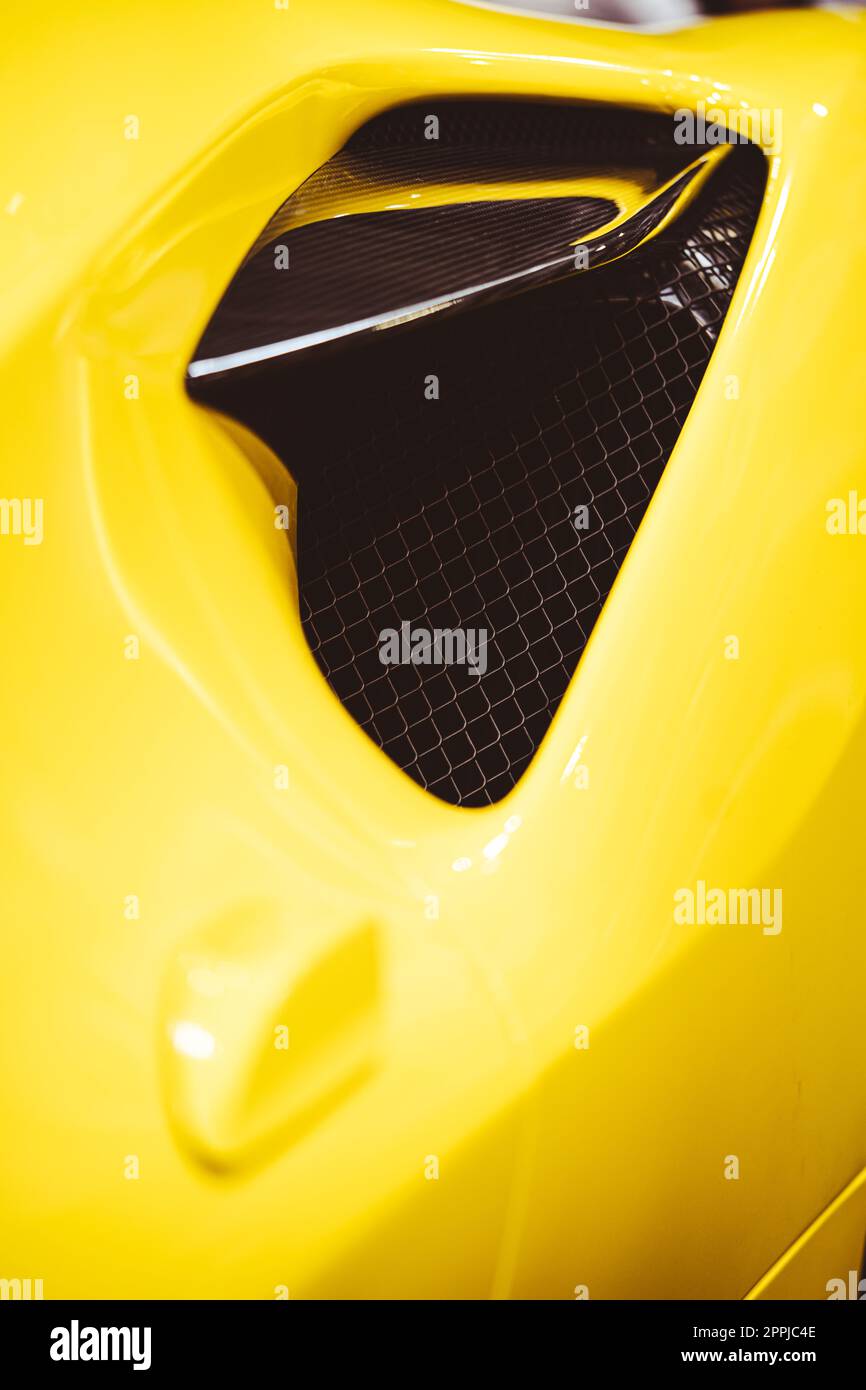 Aerodynamic yellow exotic supercar carbon part Stock Photo