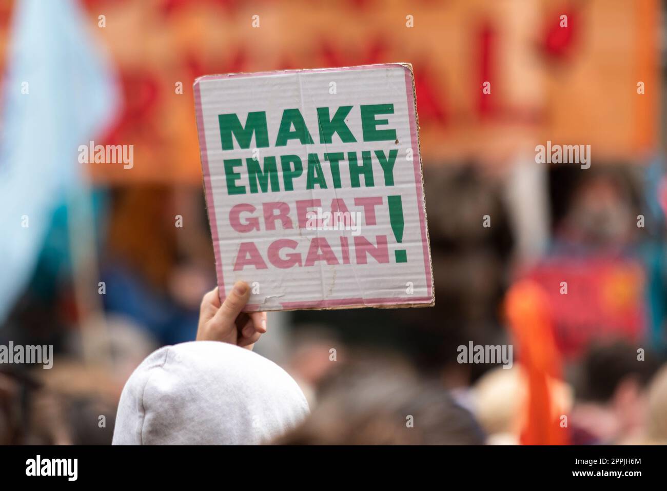 Illegal Migration Bill protest by Extinction Rebellion protesters outside the Home Office, UK. Make empathy great again placard Stock Photo