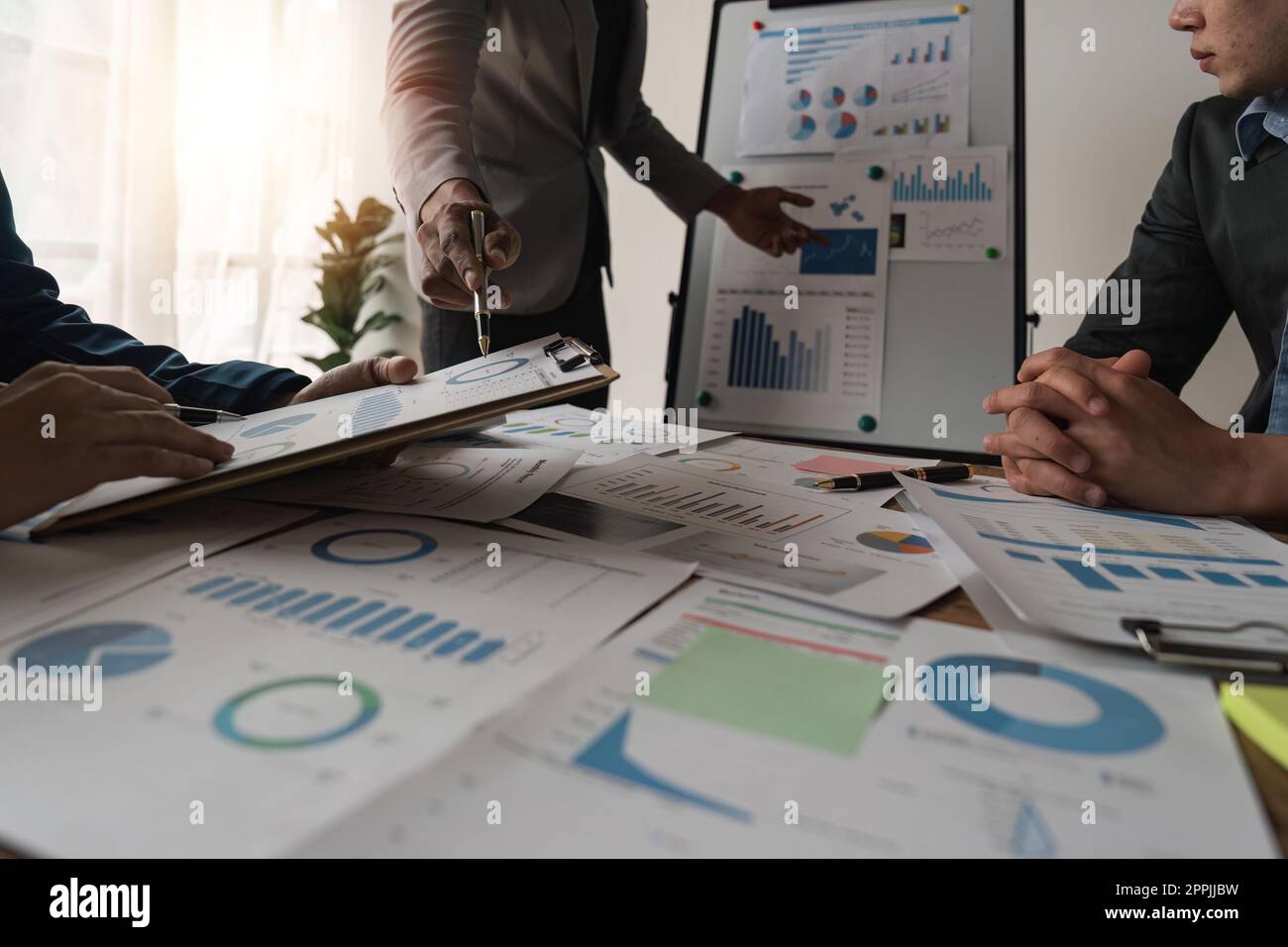 Business team analyzing income charts and graphs with laptop computer ...