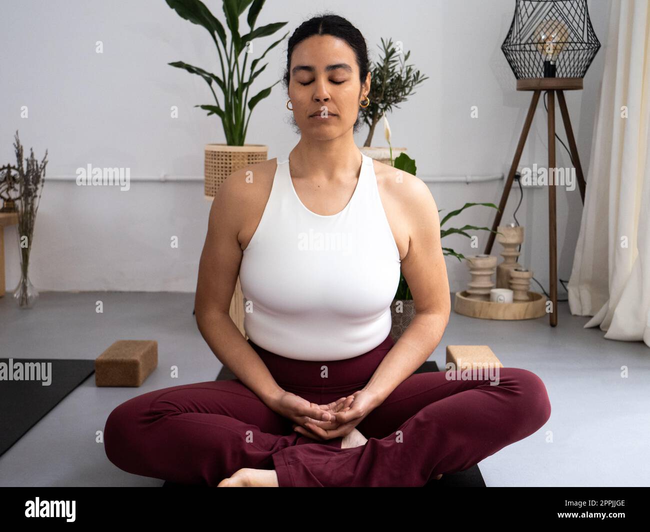Woman meditating with eyes closed in a yoga class Stock Photo - Alamy