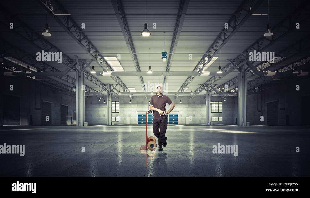 man with handtruck in warehouse Stock Photo