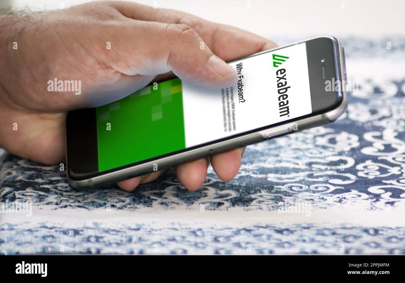 hand holding a phone with Exabeam mobile application on screen Stock Photo