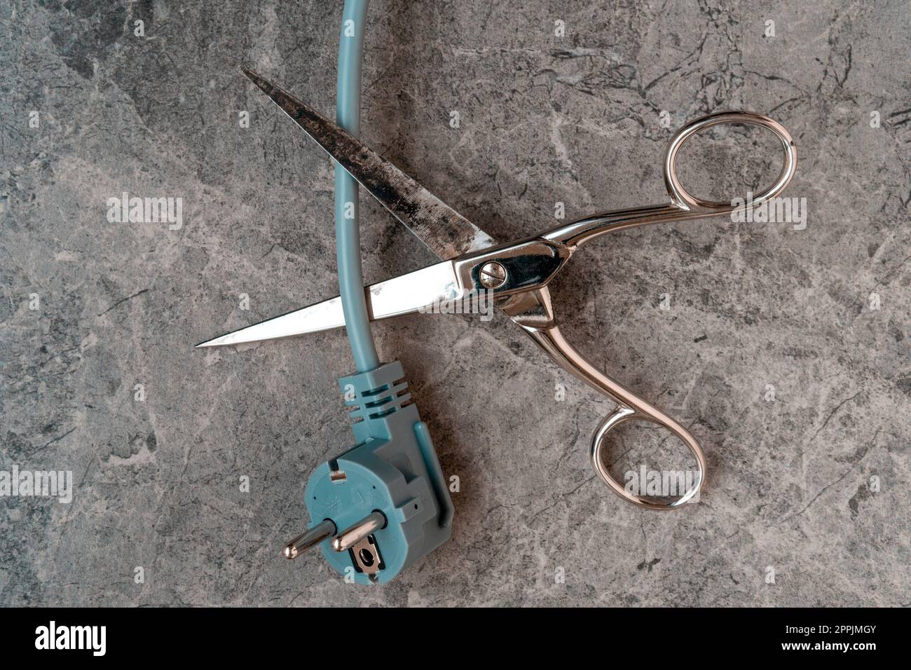 Scissors cutting electric wire Stock Photo