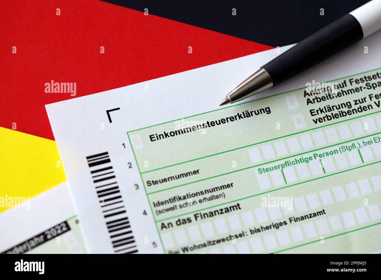 German annual tax return declaration form with pen on flag close