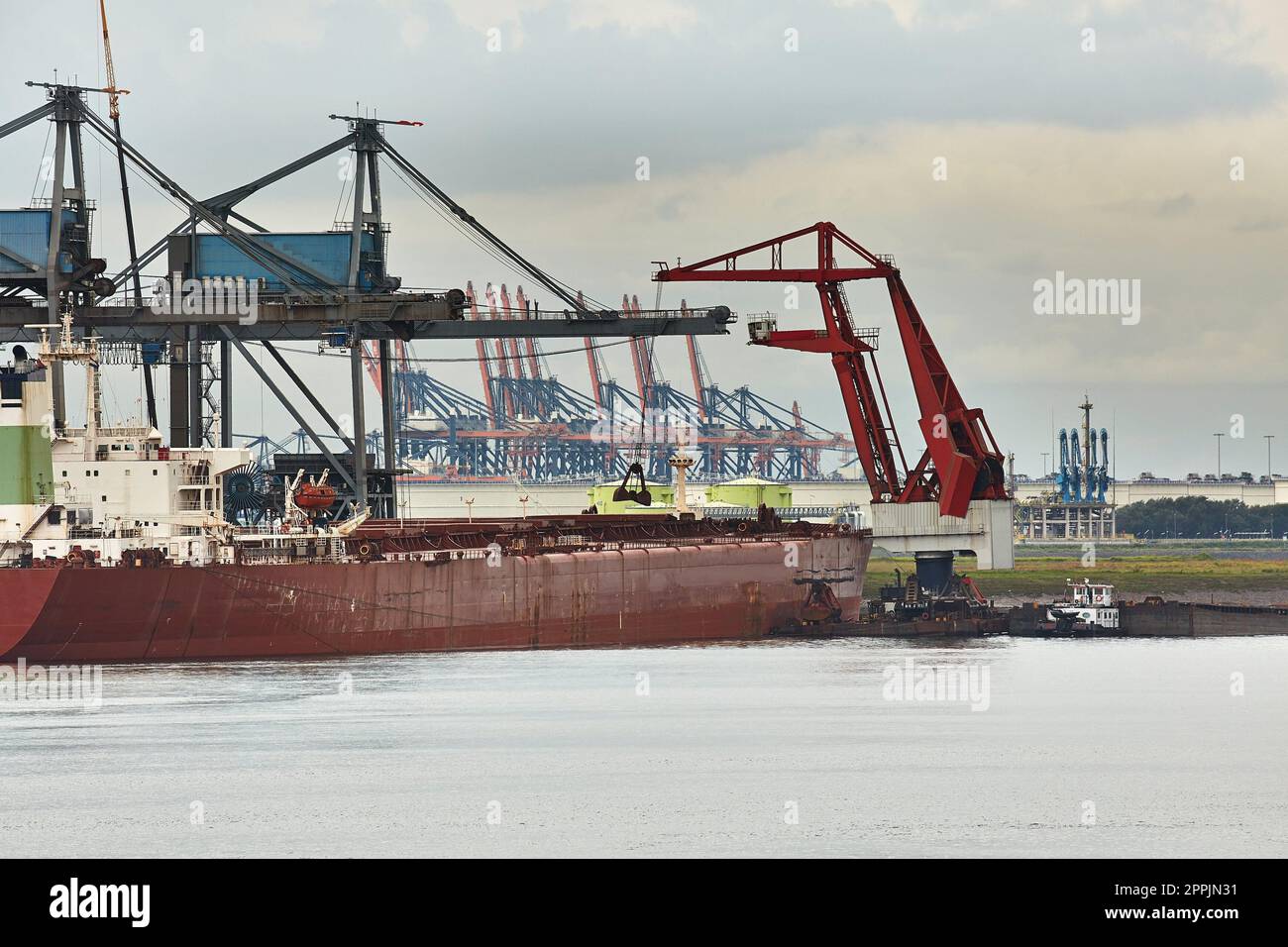 Unloading a huge ship Stock Photo