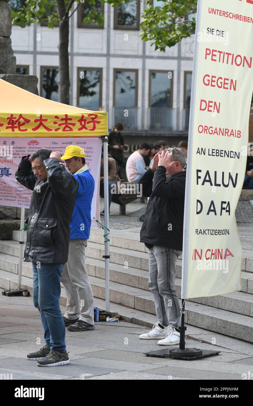 Vertical shot of people demonstrating in Cologne against organ trafficking of Falun Gong members Stock Photo