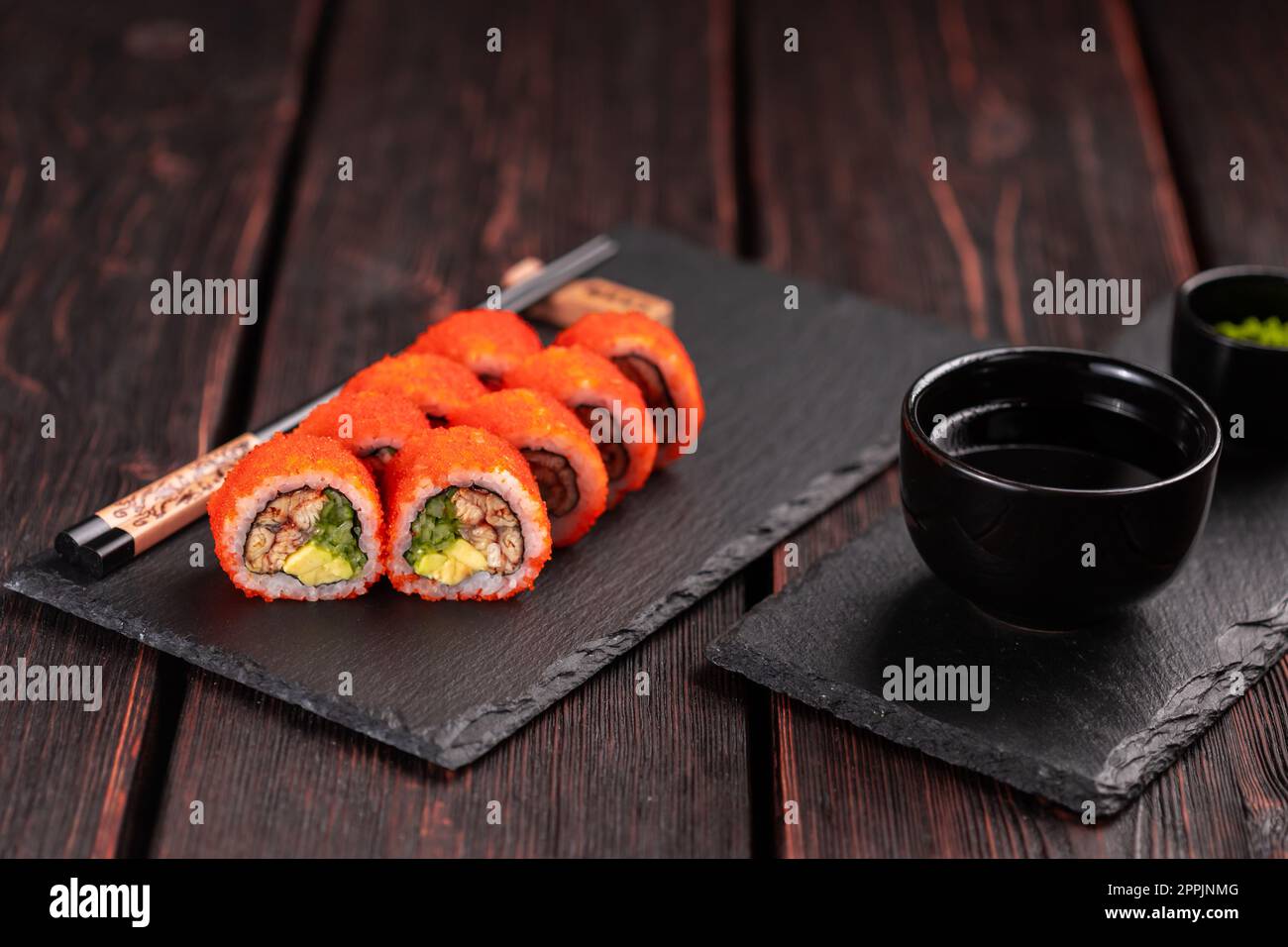 https://c8.alamy.com/comp/2PPJNMG/california-sushi-roll-with-eel-cucumber-and-tobiko-caviar-served-on-black-board-close-up-japanese-food-2PPJNMG.jpg