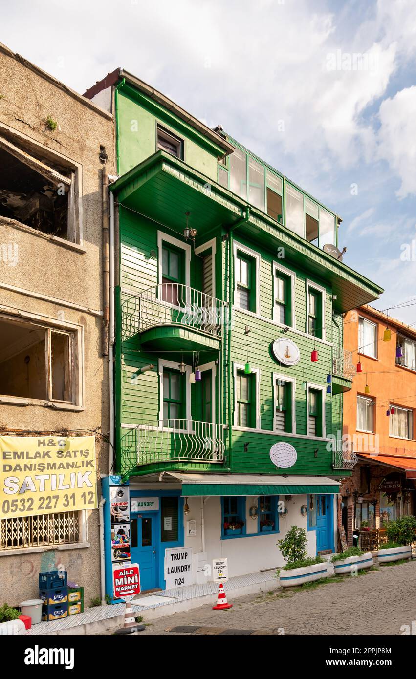 Cobblestone alley, with beautiful old houses painted in green and orange, suited in Fatih district, Istanbul Stock Photo