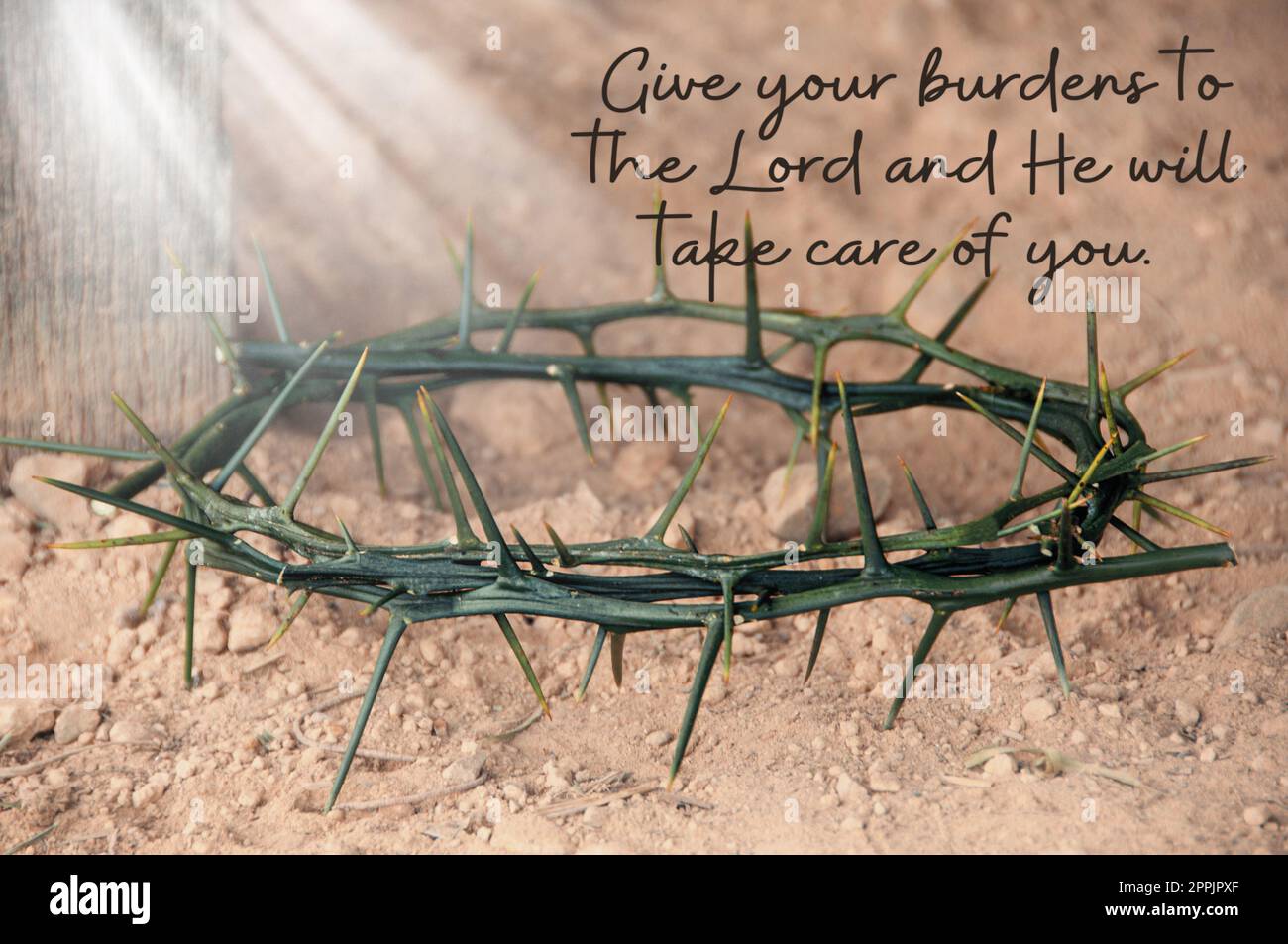 Bible verse quote - Give your burden to the Lord and he will take care of you. With shining Crown of thorns background. Stock Photo