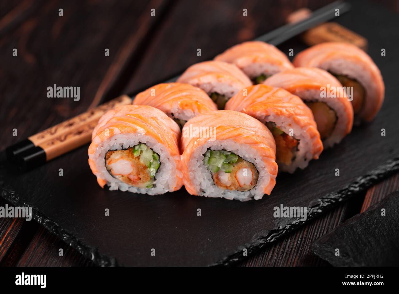 https://c8.alamy.com/comp/2PPJRH2/sushi-roll-philadelphia-with-crab-and-cucumber-and-cream-cheese-caviar-on-black-background-close-up-sushi-menu-japanese-food-concept-2PPJRH2.jpg