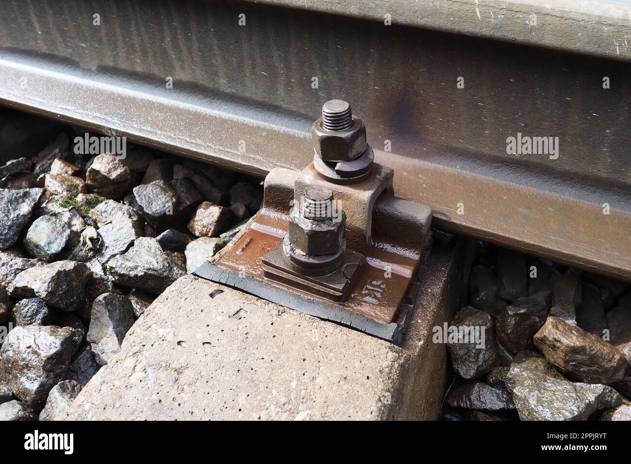 Railways. Metal steel rails and wooden sleepers. Rivets and fasteners on the railroad. Stony backfill of railway tracks. Station Nyrki, Karelia. Stock Photo