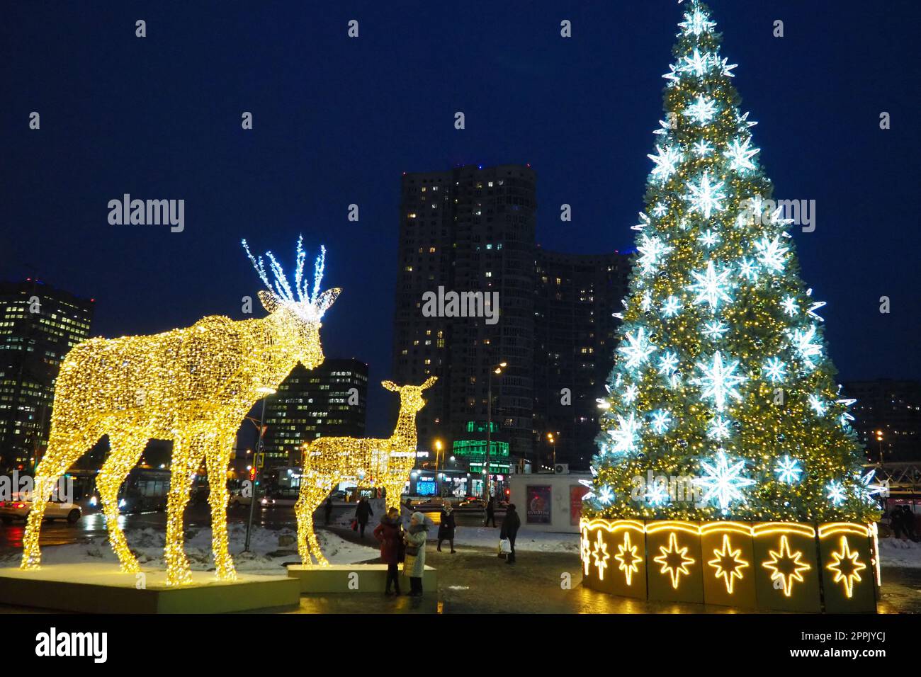 Moscow, Russia, January 17 2023 Street Christmas tree with snowflakes and festive balls. Metro Yugo-Zapadnaya. Christmas decorations in front of the mall. Silver stars, snowflakes and golden deers Stock Photo