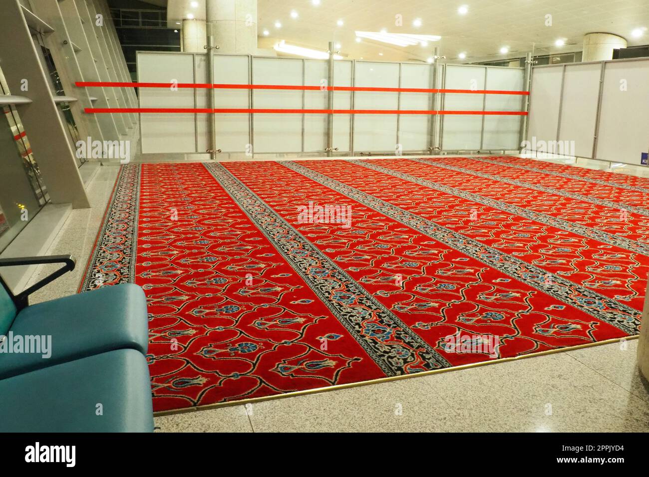 Ankara, Turkiye, Esenboga Havalimani Airport, 01.18.2023 Empty prayer hall at night. Namaz or salat is a prayer in Islam. Isha prayer. Red prayer carpet. Nobody at night. Sajjada, namazlik, jai-namaz Stock Photo
