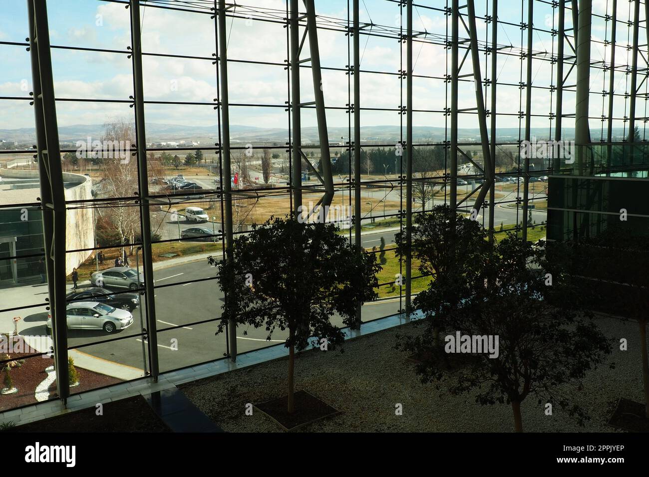 Ankara, Turkiye, Esenboga Havalimani Airport, 01.18.2023 lobby or corridor at the airport for the transit of passengers. Airport interior. Glass windows. Street, sunny weather and airport buildings. Stock Photo