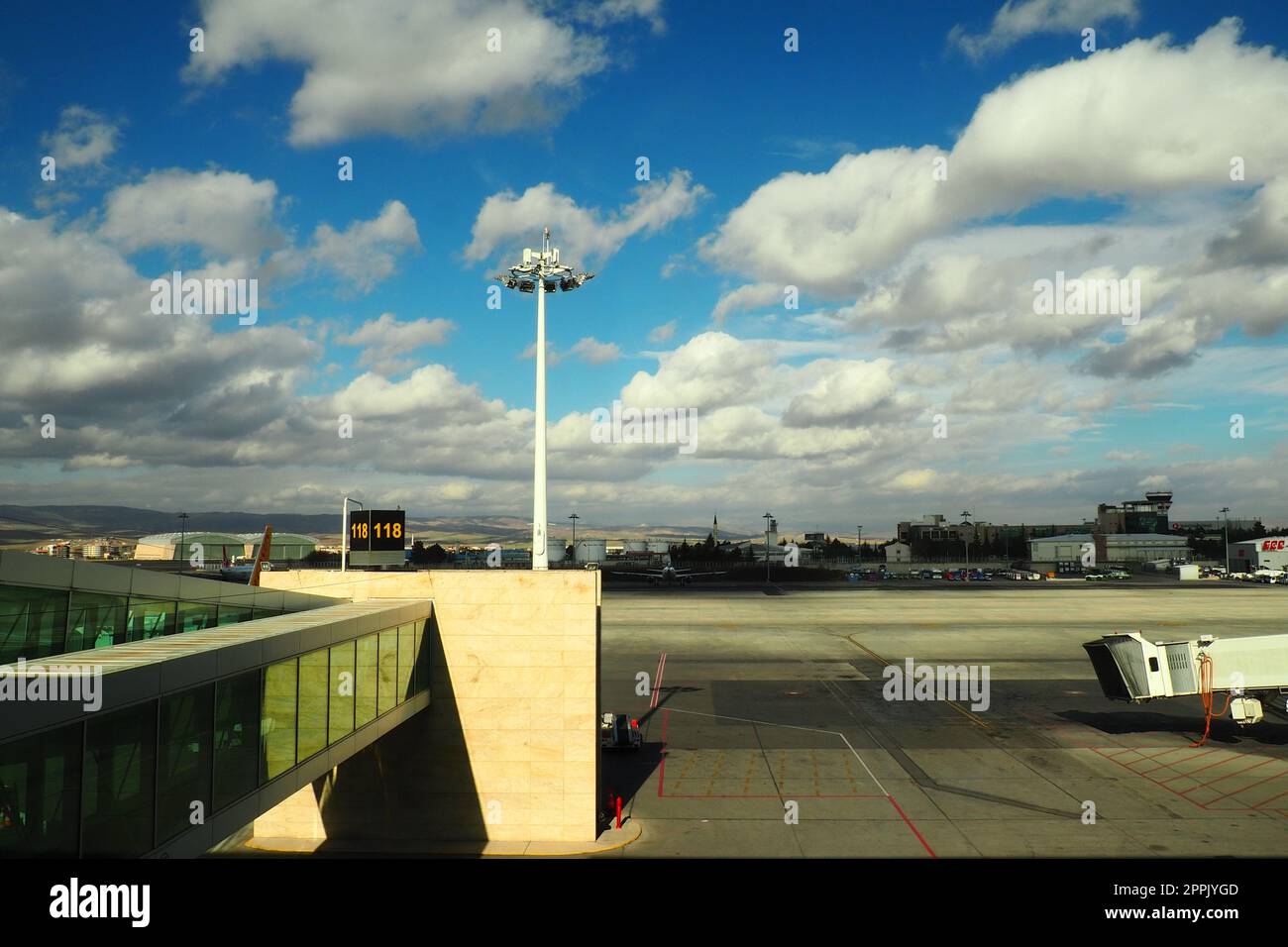 Ankara, Turkey, Esenboga Havalimani airport, 01.19.2023 View from the window of the passenger terminal on the runway area. Airplane bridge. Tower with antenna. Airport building, boarding gate. Sky Stock Photo