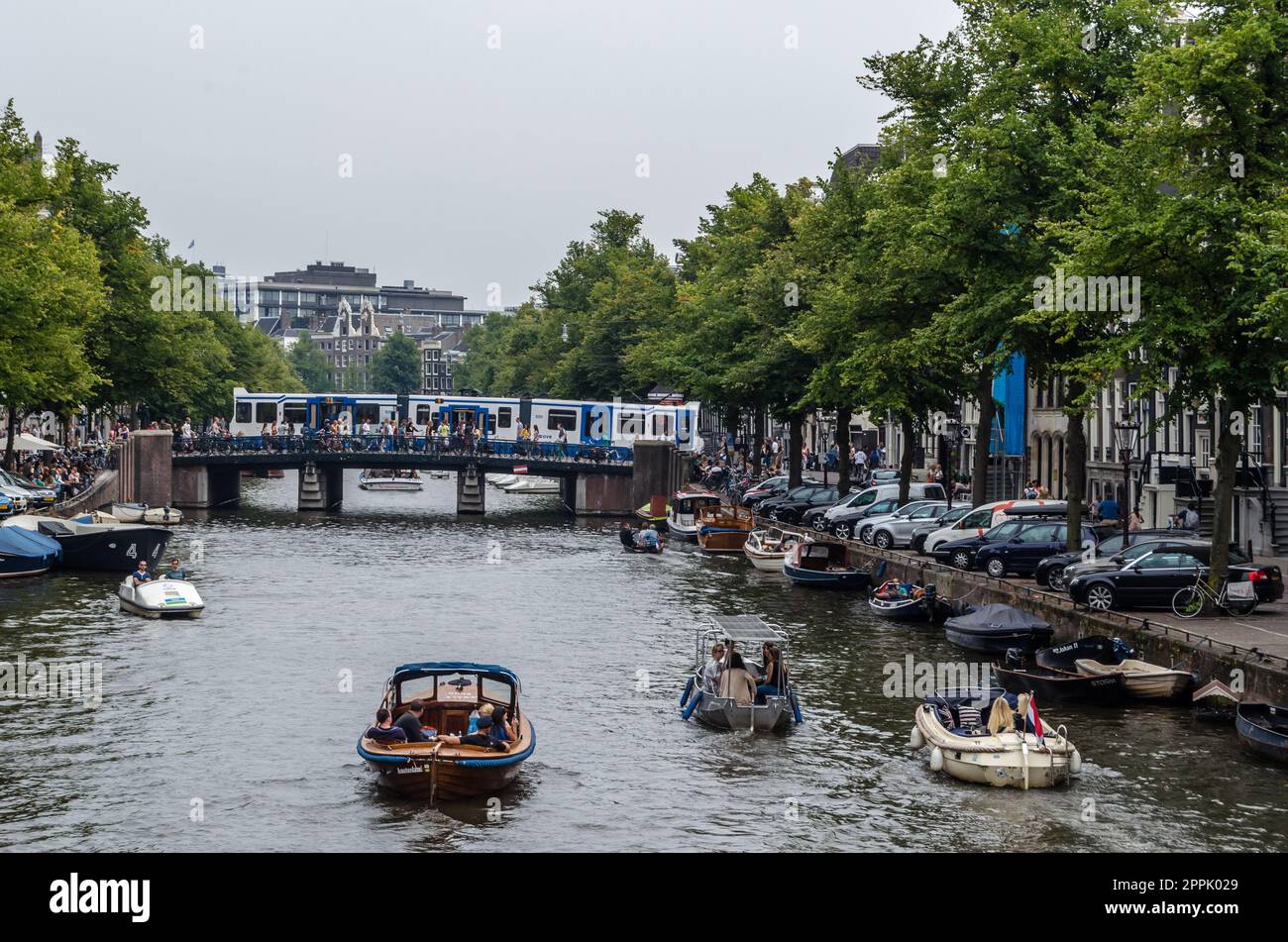 AMSTERDAM, THE NETHERLANDS - AUGUST 24, 2013: Urban landscape in Amsterdam, the Netherlands, view of streets and canals in the famous Canal District, designated as a UNESCO World Heritage Site Stock Photo