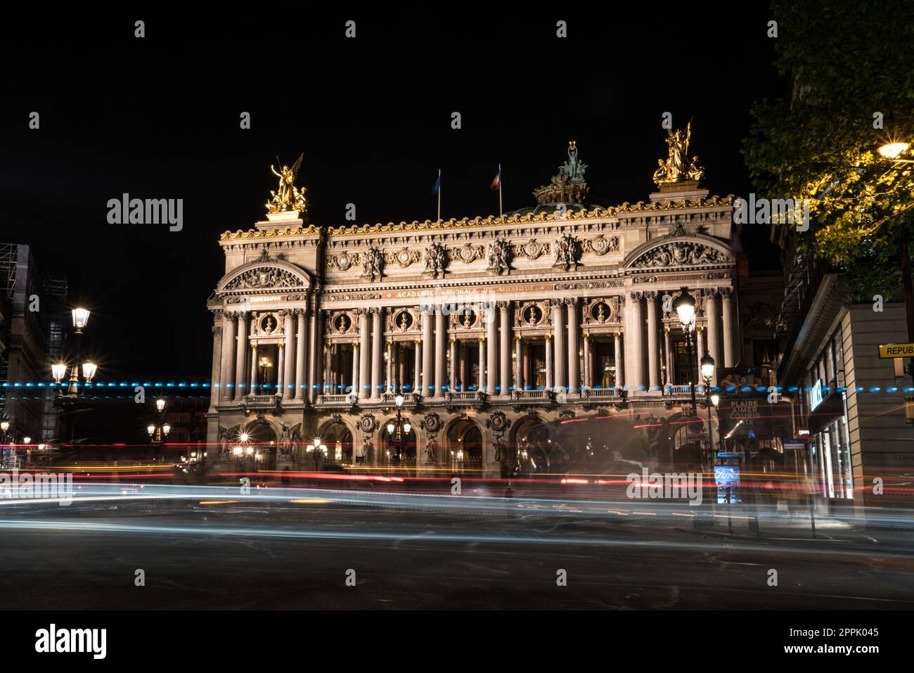 Famous Paris Opera at Night, lights of the traffic leading around Stock Photo