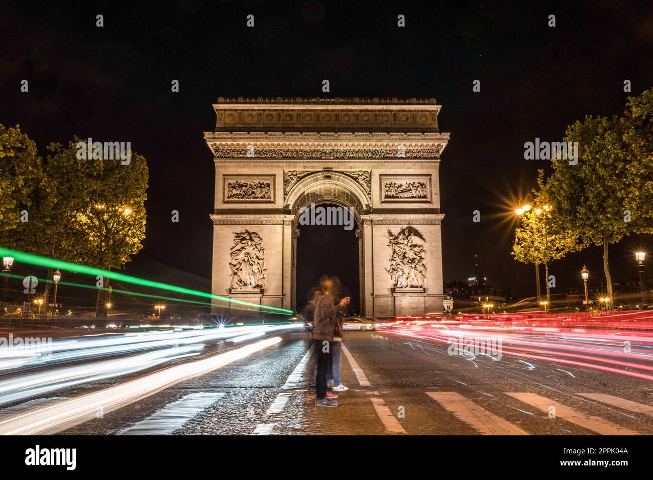 Nightly traffic on the Champs-Elysees, Arc de Triomph in the background Stock Photo