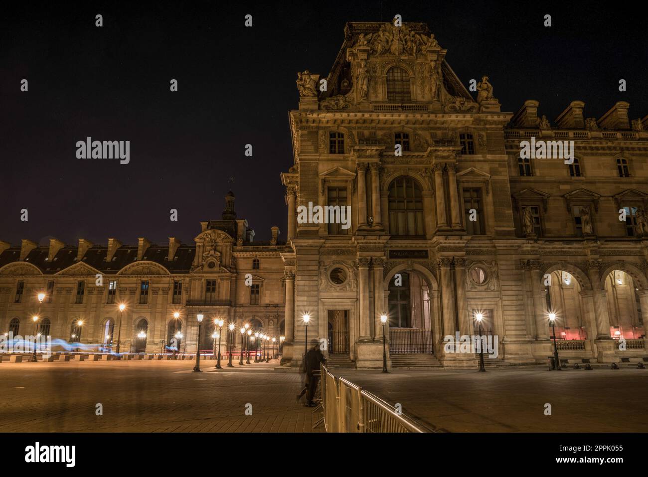 The famous Louvre Palace of Paris at night Stock Photo