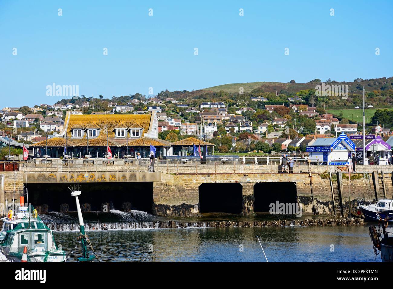 Traditional fishing boats moored in the harbour at low tide with views