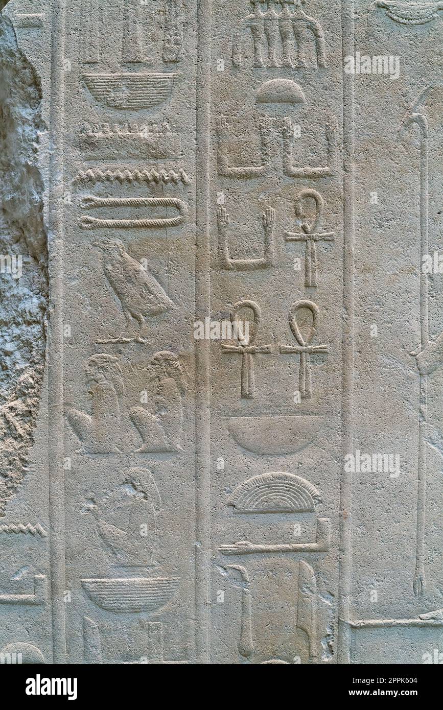 ancient text in the form of Egyptian hieroglyphics on a wall of limestone Stock Photo