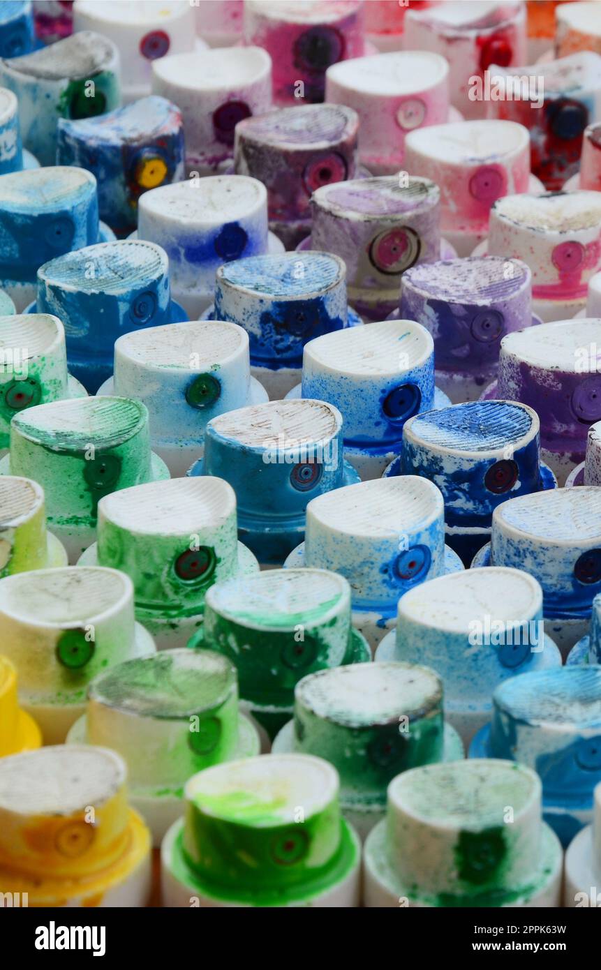 A pattern from a many nozzles from a paint sprayer for drawing graffiti, smeared into different colors. The plastic caps are arranged in many rows forming the color of the rainbow Stock Photo