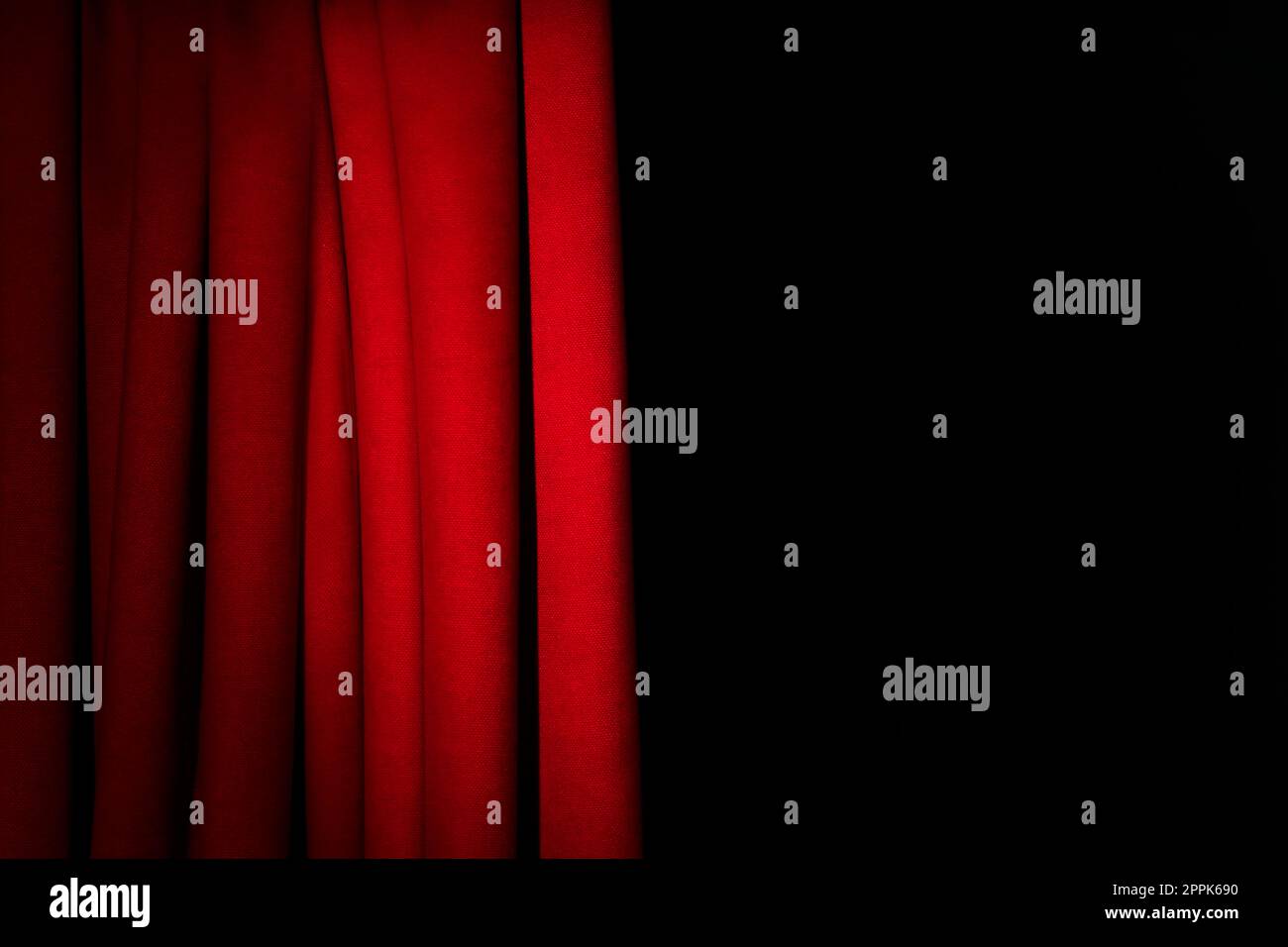 Open elegant red front curtains on black background. Space for text Stock Photo