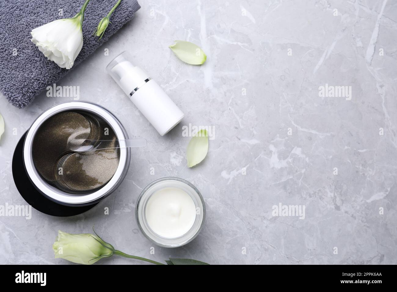 Flat lay composition with under eye patches on light grey marble table ...