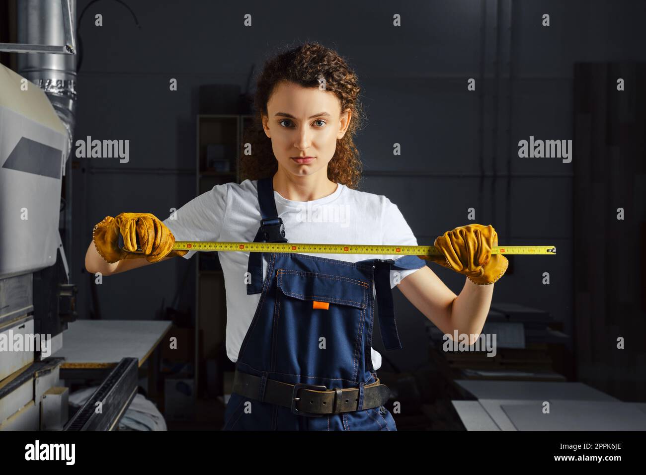 Female worker with a tape measure in hand Stock Photo