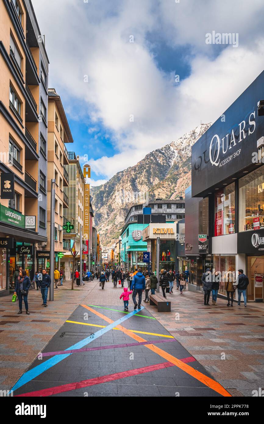 People walking and shopping on promenade with shops and restaurants, Andorra Stock Photo