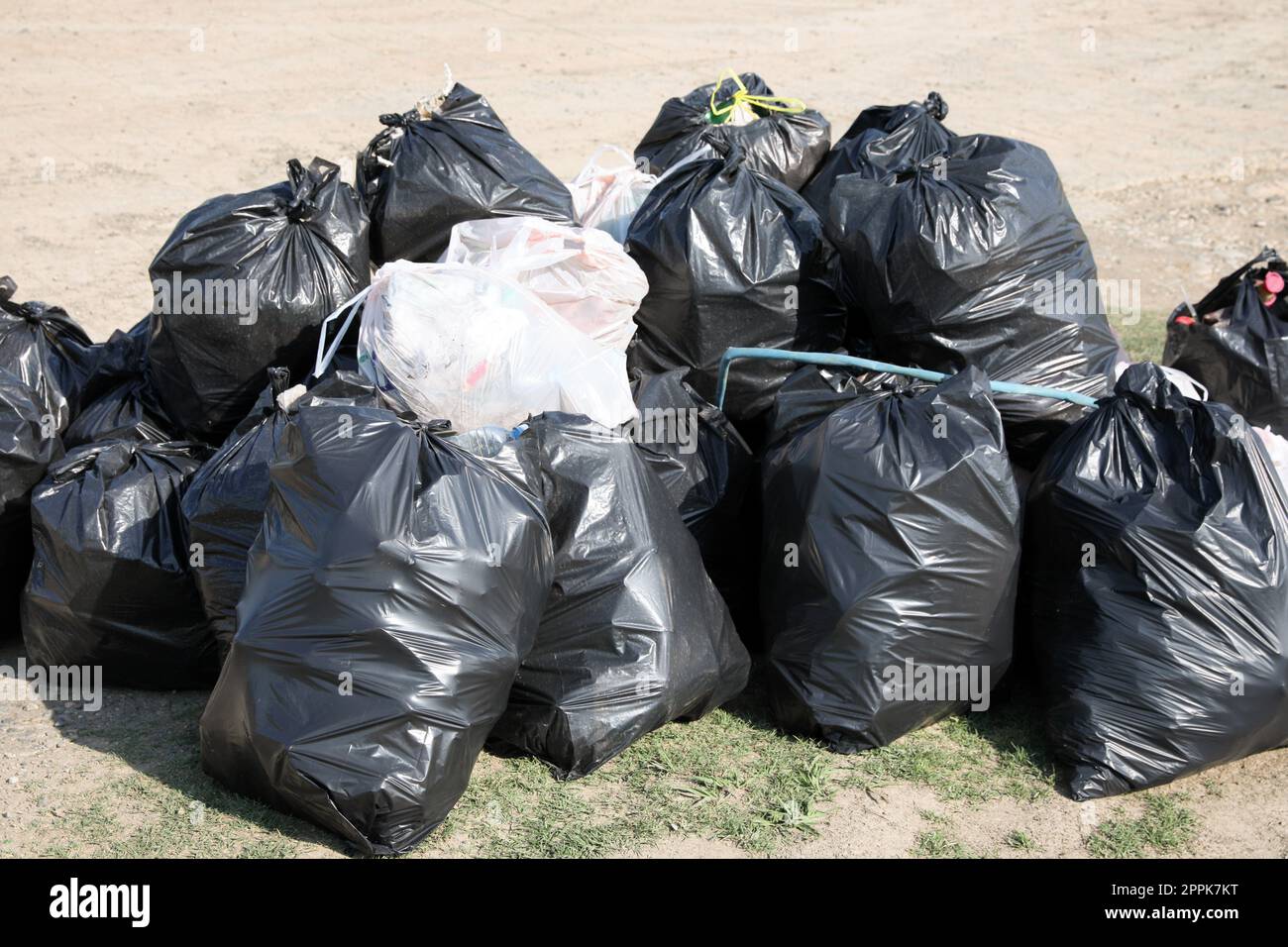 Many trash bags full of garbage outdoors. Environmental Pollution concept Stock Photo