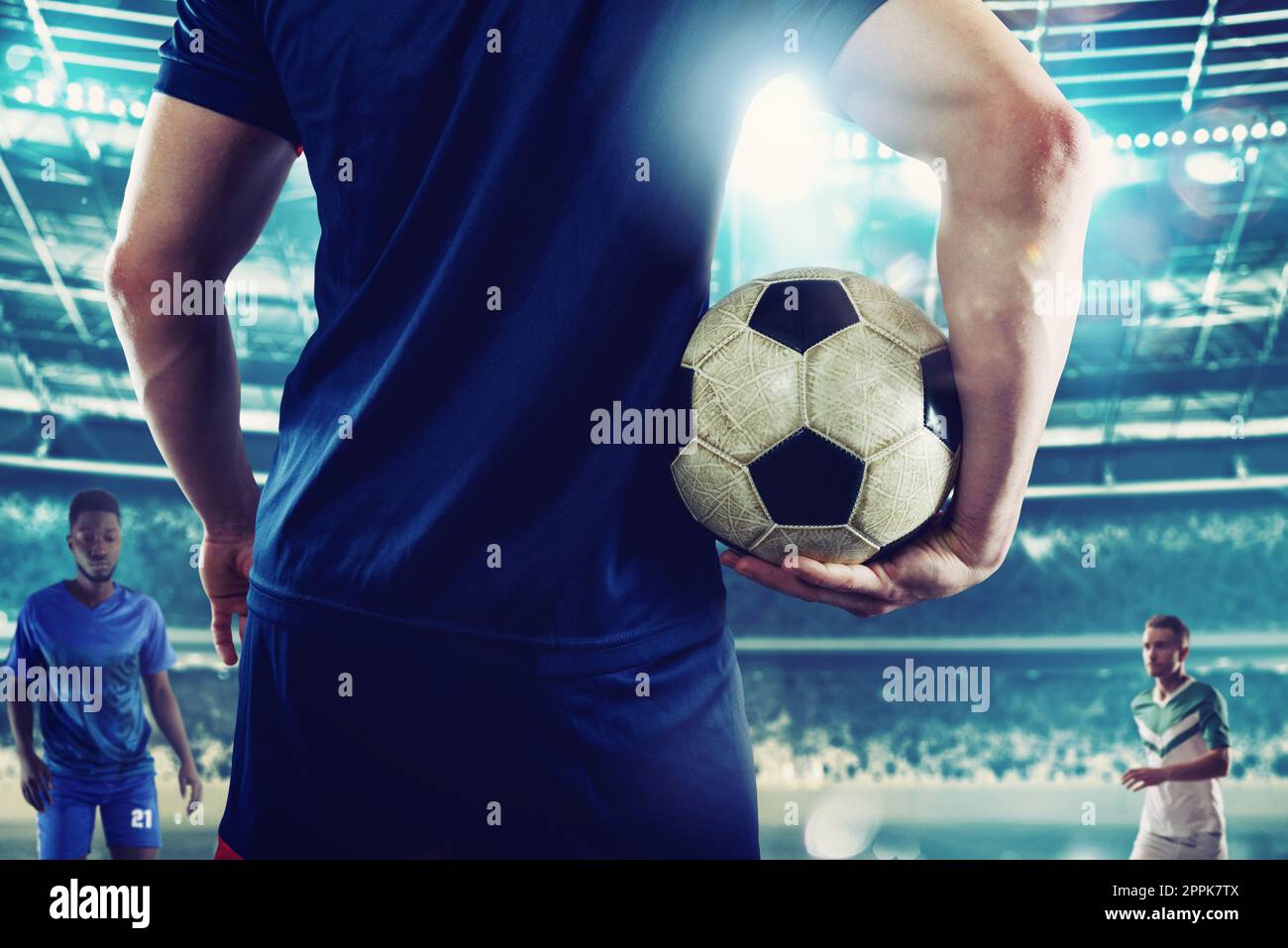 Football player with to play with soccerball against opposing team Stock Photo