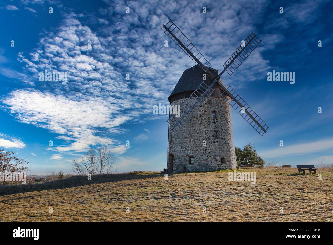 Windmill in the field in the daytime. Stock Photo