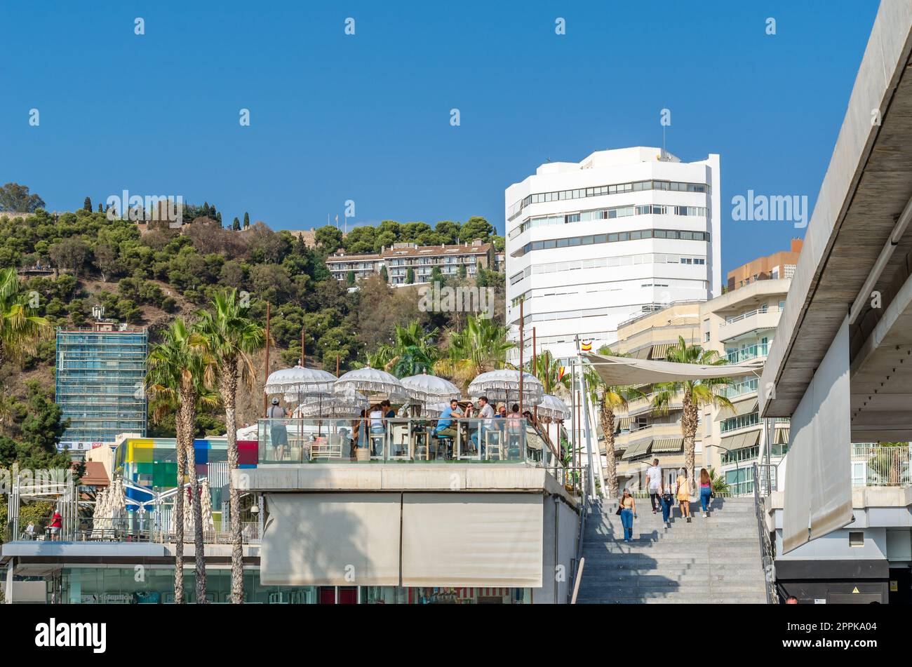 MALAGA, SPAIN - OCTOBER 12, 2021: 'Muelle Uno', an outdoor shopping area with a variety of modern shops and restaurants along the promenade in Malaga, Spain Stock Photo